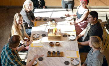 A group of people have a discussion around a long table