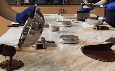 Chocolate being poured onto a table